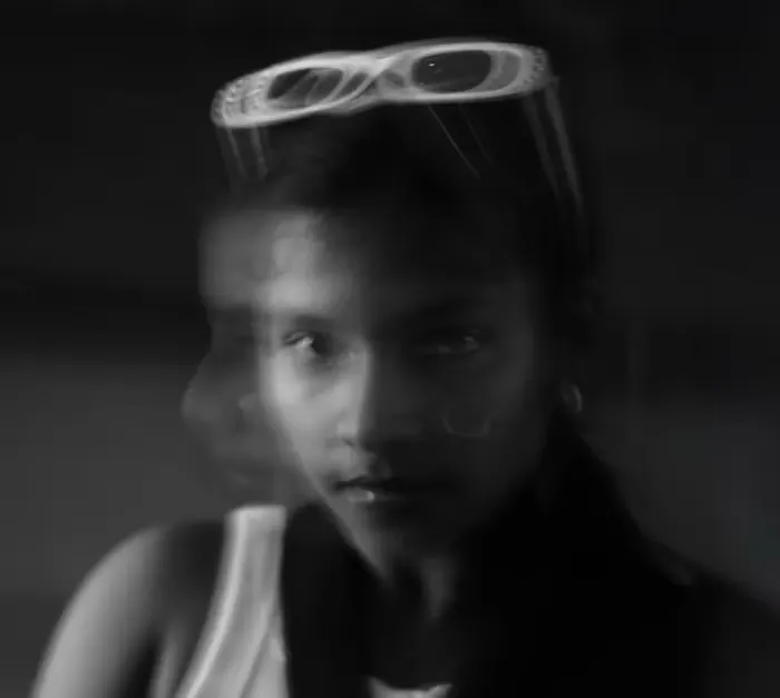 Black and white motion portrait of a woman in sunglasses