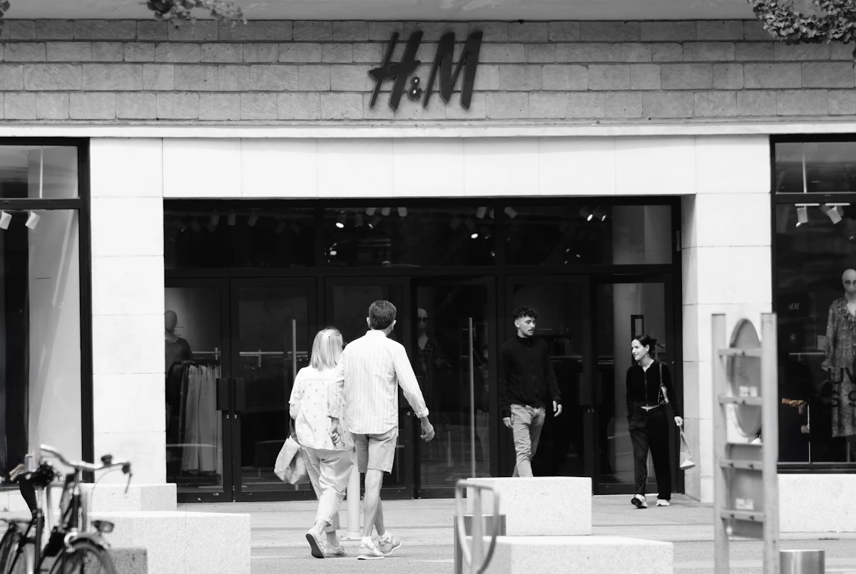 Black and white street photograph of people outside a store in Nantes